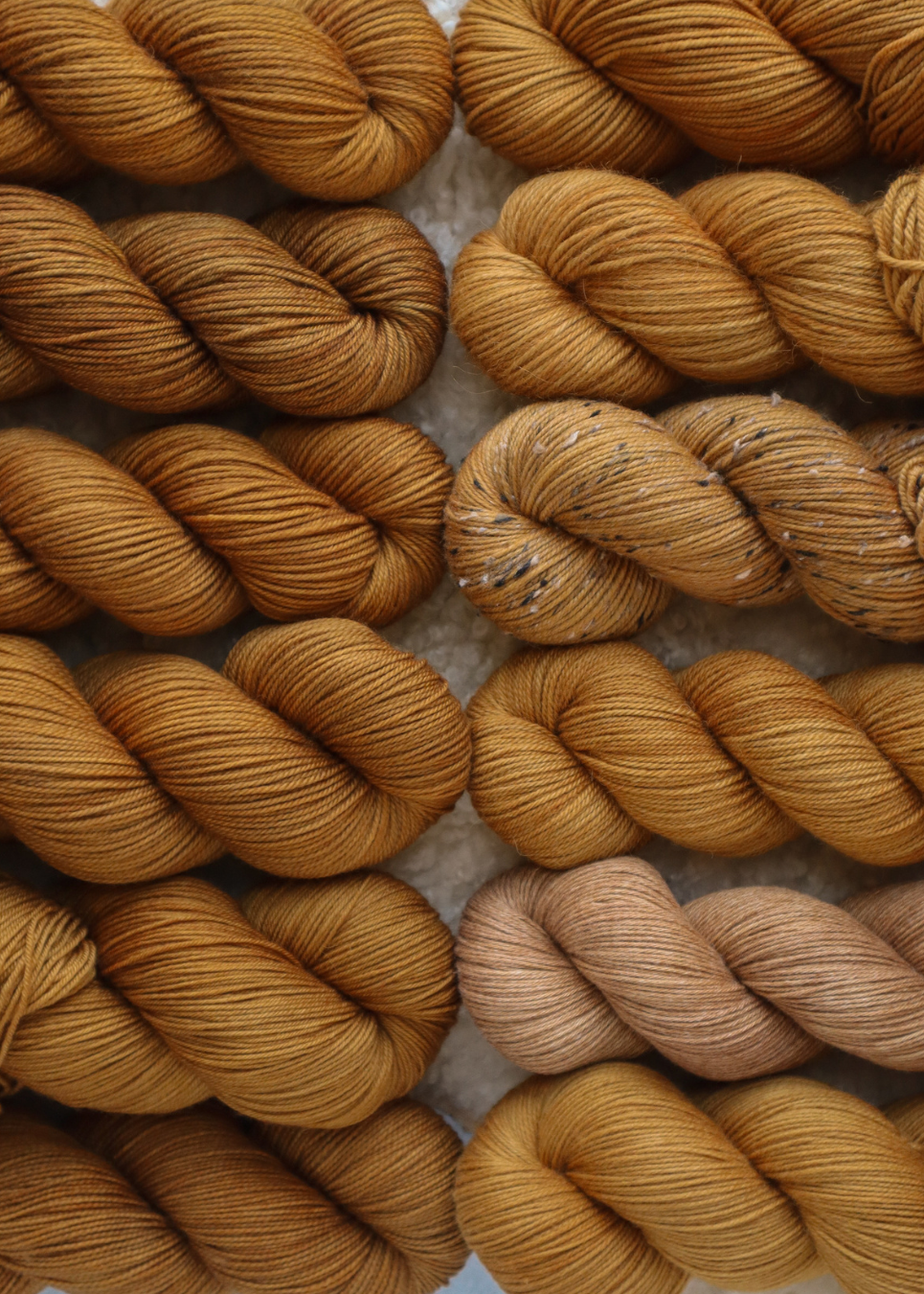 Close-up of brown yarn skeins on a textured surface
